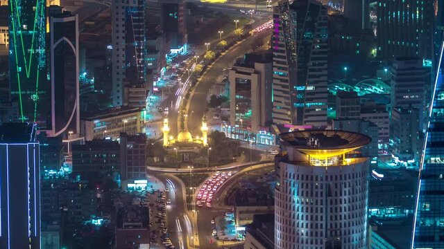 Skyline with Skyscrapers night timelapse in Kuwait City downtown illuminated at dusk. Aerial view from rooftop. Kuwait City, Middle East.