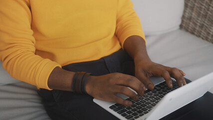 Close up, black man using laptop indoors. High quality photo