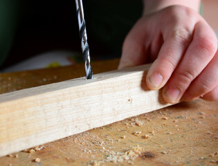 the child drills with an electric drill. home renovation concept, help father, do it yourself, growing up.