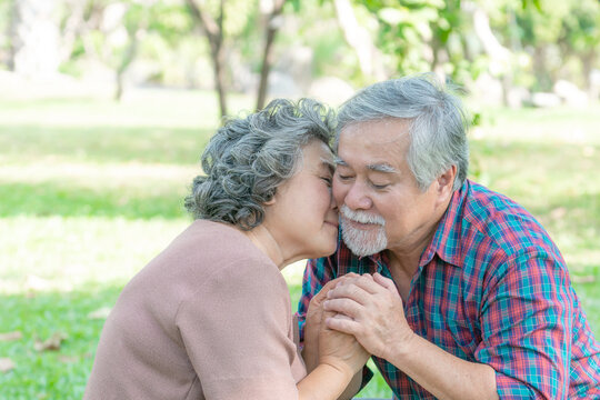 elderly woman kiss on cheek of his husband in the forest parks