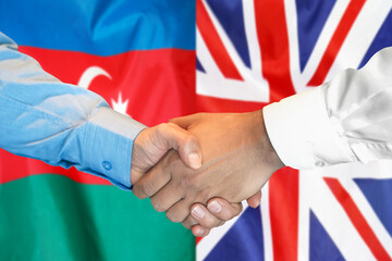 Business handshake on the background of two flags. Men handshake on the background of the Azerbaijan and UK flag. Support concept.