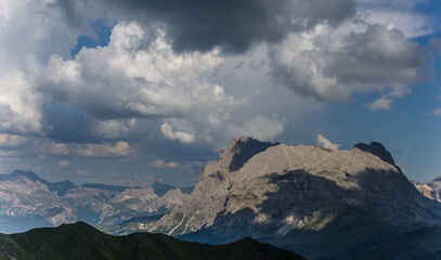 View of Sassolungo and Sassopiatto mountains as seen from Alpe di Tires refuge on a cloudy and misty evening, Dolomites, Trentino, South Tirol, Italy.