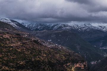 Fototapeta premium Kalarrytes village in Tzoumerka mountain range, view of summits in winter