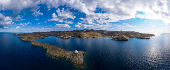 Greece, Kea Tzia island. Lighthouse on rocky cape, sky, sea background. Panorama.
