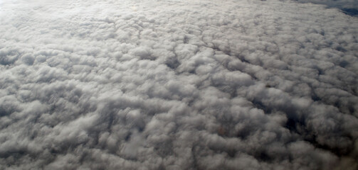 Aerial view of clouds and sky. Bird eye view from airplane window. Clouds panorama from airplane. Flight from Kiev to Sharm El Sheikh, Egypt.