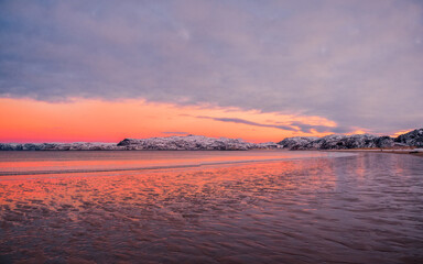 Fototapeta premium Amazing sunrise polar landscape with white snowy mountain range on the horizon. Arctic ocean panoramic view
