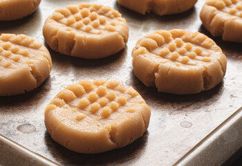 Peanut butter cookies ready for the oven on rustic baking sheet