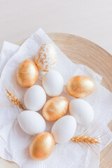 Golden, marble and white Eggs on  wooden plate in nature background. A background for celebrating Easter Top view and copy space Flatlay. Generous accommodation for copy space.