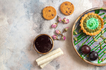 top view yummy creamy cake with tea on light desk sweet photo candy biscuit