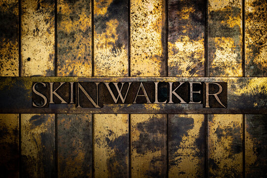 Skinwalker text on grunge textured copper and gold background