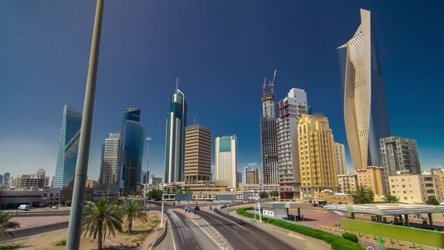 Kuwait City skyline with skyscrapers timelapse hyperlapse in downtown. View from bridge with traffic on the road. Kuwait City, Middle East.
