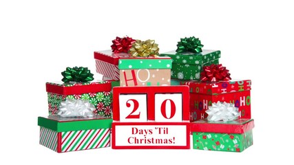 HD Video Countdown 25 to 1 days until Christmas white wood blocks in a red box with presents stacked on and around it. Isolated on a blizzard white out background.
