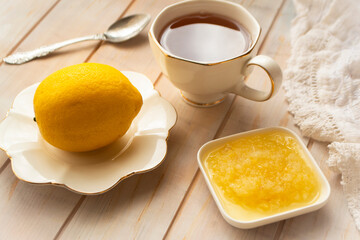 Fresh raw ginger with grated lemon and tea on white table