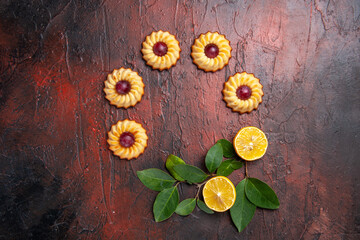 Obraz na płótnie Canvas top view sugar cookies with lemon on dark background biscuits sweet dessert