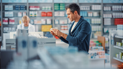 Pharmacy Drugstore: Portrait of Handsome Young Man Browsing Shelves to Buy Medicine, Drugs,...
