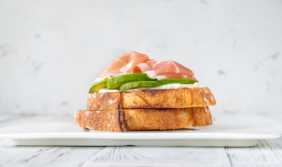 Toast with avocado, prosciutto and cream cheese