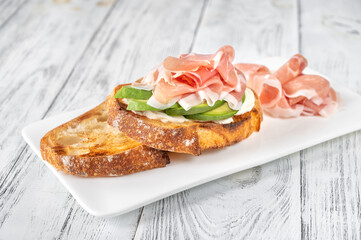 Toast with avocado, prosciutto and cream cheese