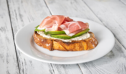 Toast with avocado, prosciutto and cream cheese