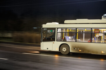 Dirty bus rushes along the night highway