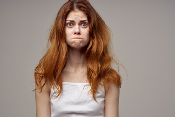 red-haired woman emotions model white t-shirt health problems