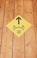 Sign indicating covid safe social distancing and one way