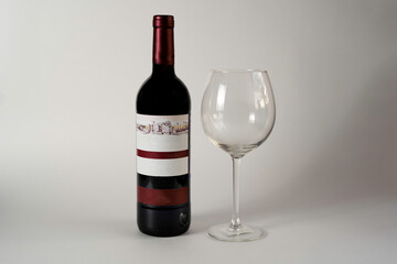 red wine bottle and glass on white background
