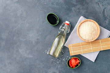 Composition with rice vinegar on dark background