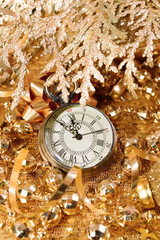New Year's clock. Decorated with gold tinsel and Christmas decorations. Congratulatory background - 400434211
