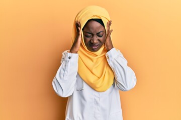 Beautiful african young woman wearing doctor uniform and hijab with hand on head, headache because stress. suffering migraine.