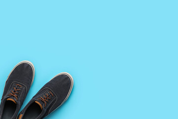 Casual male shoes on color background