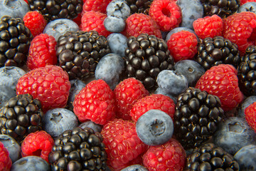 Ripe fresh berries of blackberry, blueberry and raspberry berries.Close up. Selected focus.
