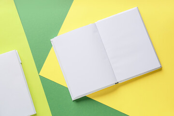 Blank books on color background