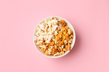 Bowl of popcorn on color background