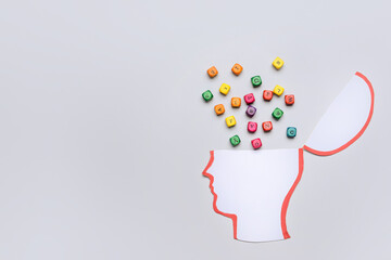 Scattered letters in head on light background. Stress concept