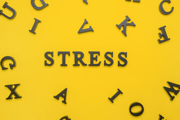 Word STRESS and letters on color background