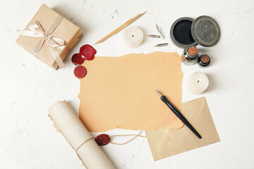 Composition with nib pen, paper sheet and inkwells on table