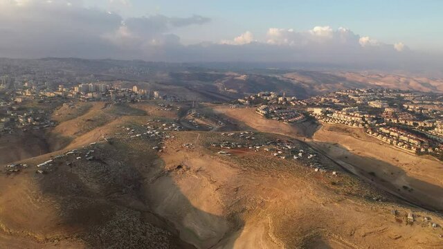 Israel and Palestine town living side by side, aerial view
maale adumim and al-eizariya town aerial view, judea desert December 2020
