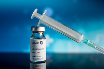 covid 19 vaccine and injector, color background