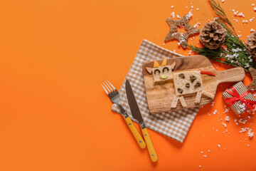 Tasty sandwich in shape of bull and New Year decor on color background