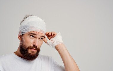 man in white t-shirt bandaged head health problems injury treatment