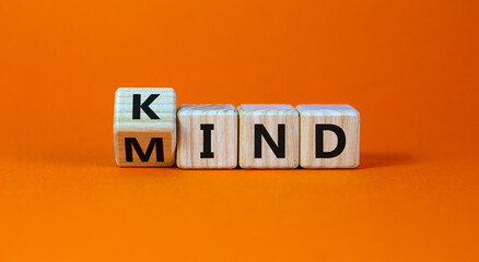 Have a kind mind. Turned cubes and changed the word 'kind' to 'mind' on a beautiful orange background. Business and kind mind concept. Copy space.