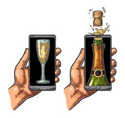 Male hand hold smartphone with bottle of champagne explosion cork and glasses