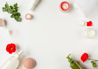 Spa and beauty. A set of organic cosmetics and red buds are located around the perimeter of the image.  White background with items of natural cosmetics. Free space for text.