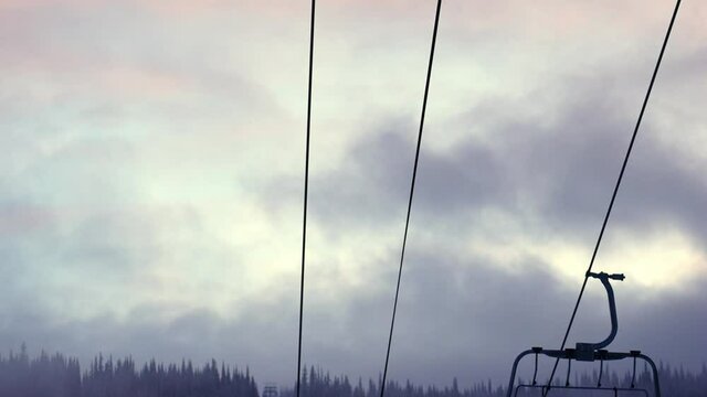 Ski resort with empty alpine skiing tracks and stopped ski lift. 