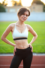 Fototapeta premium Slender woman posing at the run track