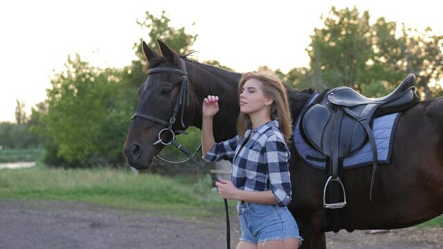 Girl with hourse. Smiling woman and her horse on the farm