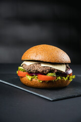 fresh tasty burger on black background