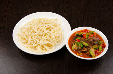 meat with salad, sauce, pepper, pasta. Asian cuisine,