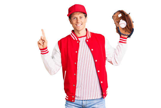 Young handsome man wearing baseball uniform holding golve and ball surprised with an idea or question pointing finger with happy face, number one