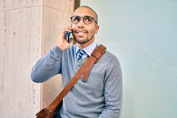 Young african american businessman smiling happy talking on the smartphone at the city.